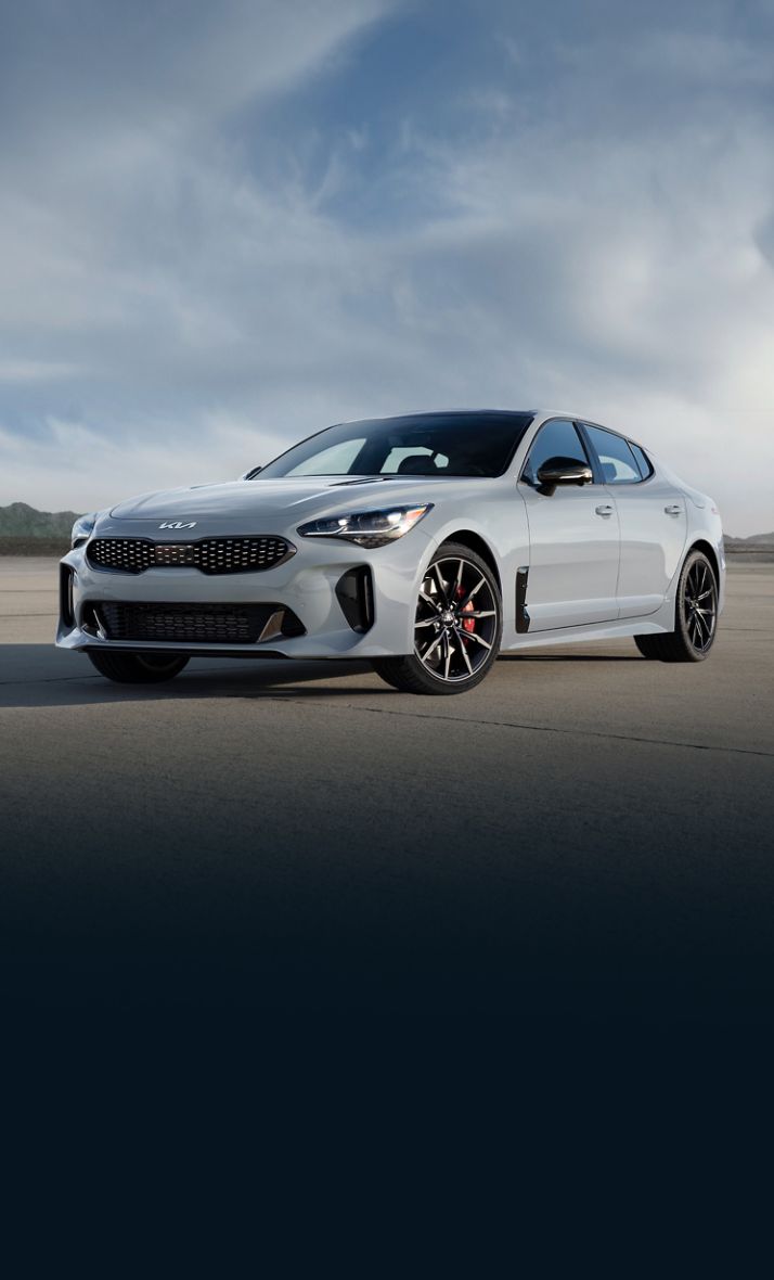 2022 Kia Stinger Parked In Front Of A Mountain Three-Quarter View