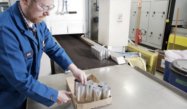 pulling beverage cans from oven line