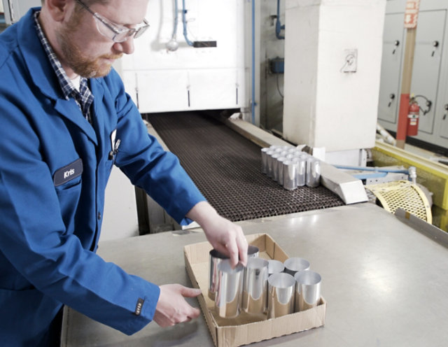 pulling cans from beverage can oven