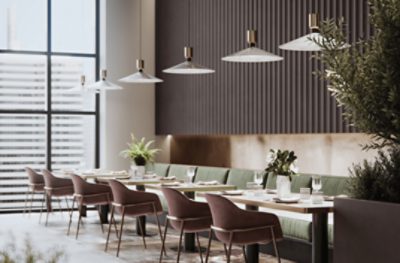 The modern interior of a restaurant with sage cushioned bench seating along a wall across from deep red single chairs.