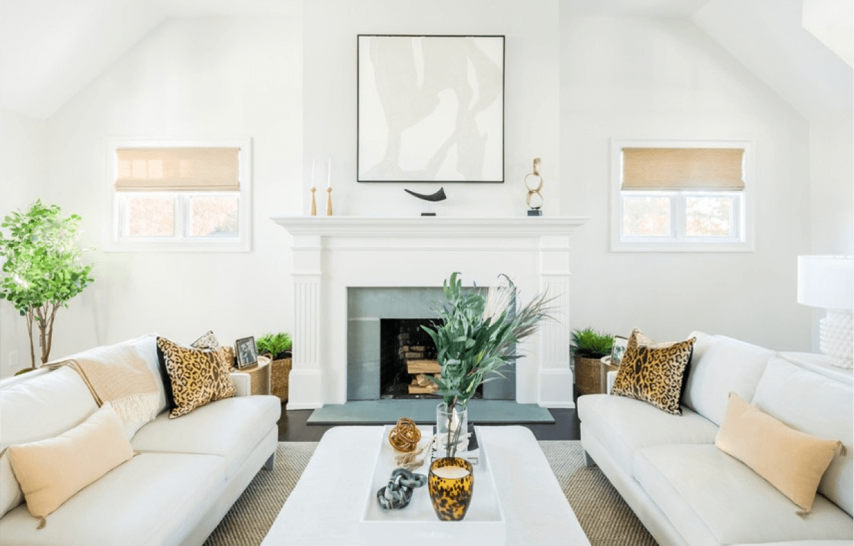A living room with bright white walls and furniture with small pops of color throughout.