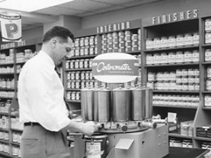 A man using a color mixing machine