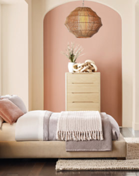 bedroom featuring a large bed, nightstand and dresser in a light wood finish