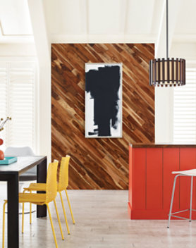 a modern kitchen interior featuring a decorative wooden wall and bright cabinetry