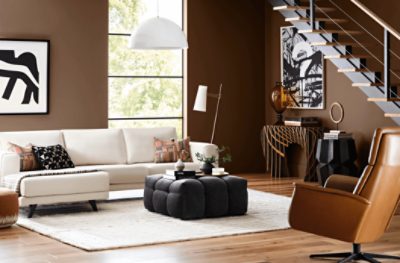 A large living room with a floor to ceiling window, modern art and walls painted in SW 6089 Grounded.