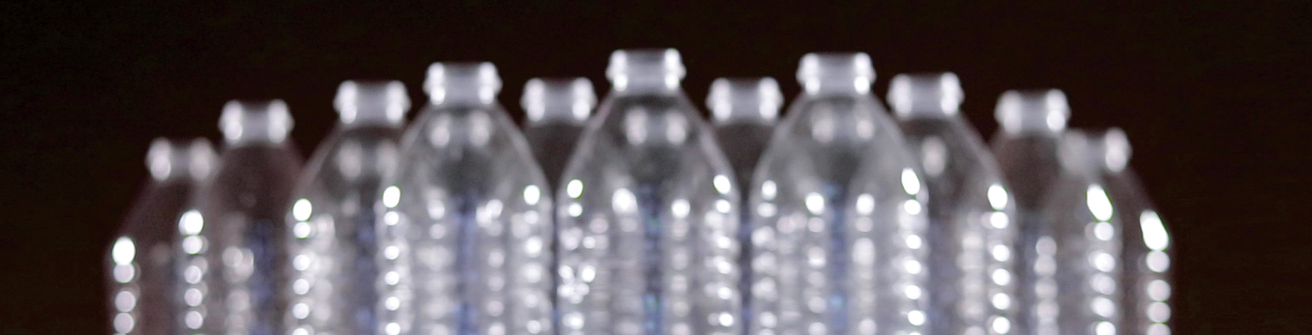 plastic bottles with pile of powder in front of it