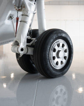 closeup of aircraft tire on shiny new hangar floor