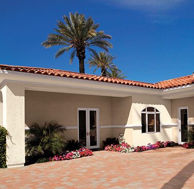 A Spanish-style exterior home with cream paint and orange roof.