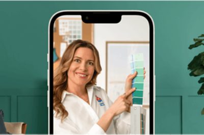 An iPhone promoting a virtual color consultation with a person holding up some color cards.