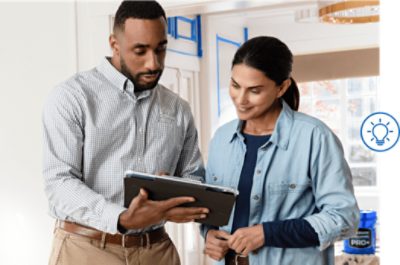 Two people looking at a tablet.