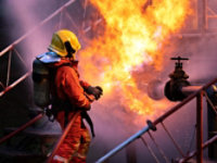 Firefighter spraying a fire