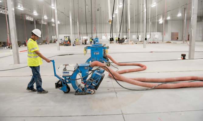 person operating floor grinder