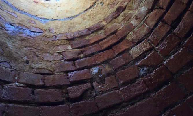 brick manhole with cracks