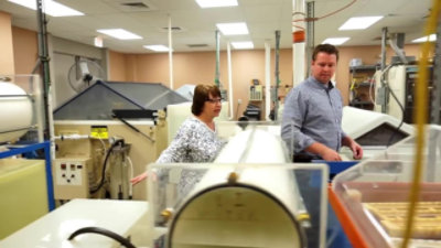 a man and a woman in a factory