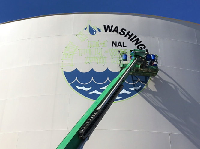 Water tank with logo being applied