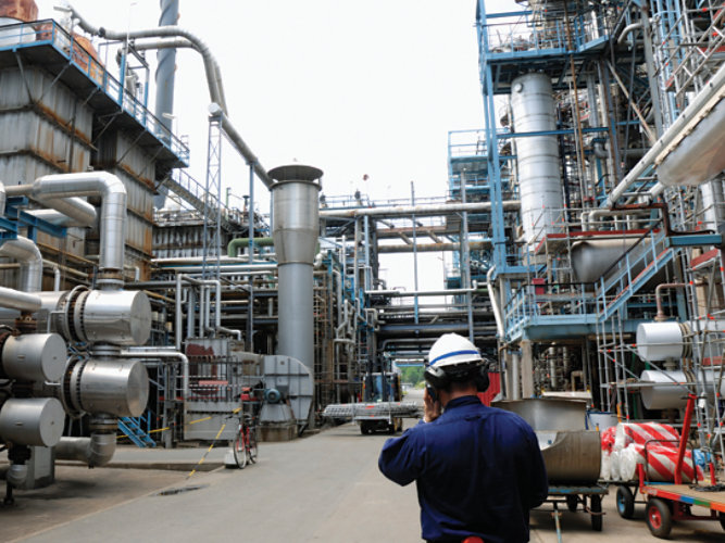Male standing inside a power generation plant