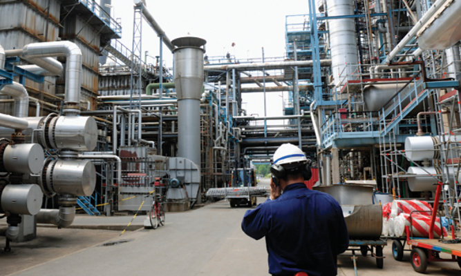Man on mobile phone whilst in a refinery
