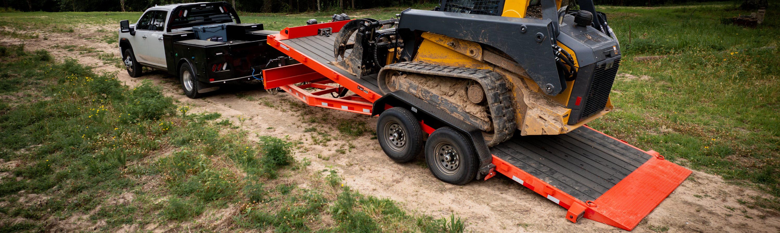 pick up truck pulling a dozer on a tilt trailer