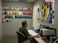 Technician surrounded by color panels on wall