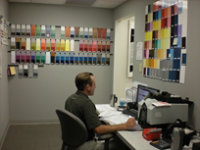Technician surrounded by colour panels on wall