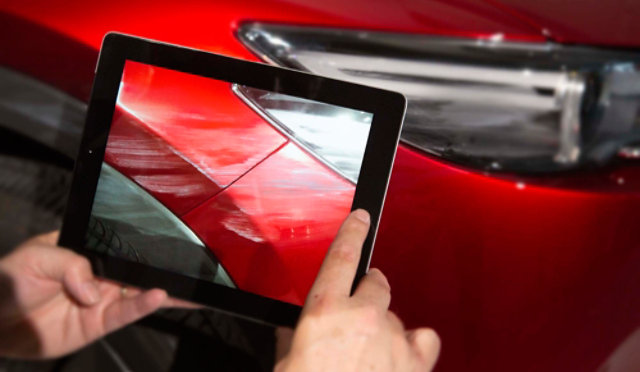 Person taking a photo of car damage