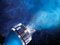 Close up of a spray gun nozzel, sparying paint.