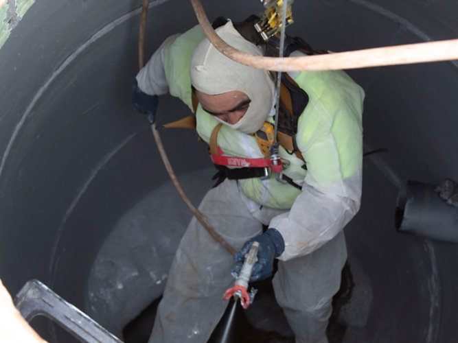 Dura-Plate 6100 being spray applied in a manhole