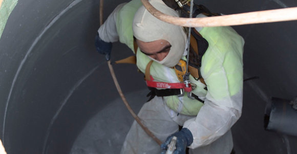 Man inside manhole applying Dura-Plate 6000