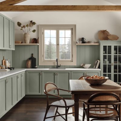 A large open kitchen with wooden cabinets and boards painted in SW 9130 Evergreen Fog.