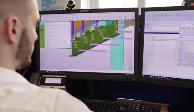 A FEET engineer examines a computer diagram