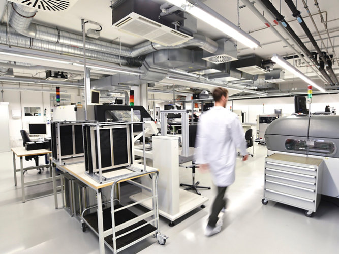 A man walking through a semiconductor production facility