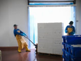 factory worker taking note of food prep