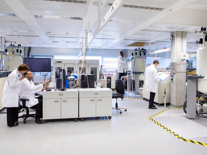 Scientists working in a laboratory with resinous flooring.