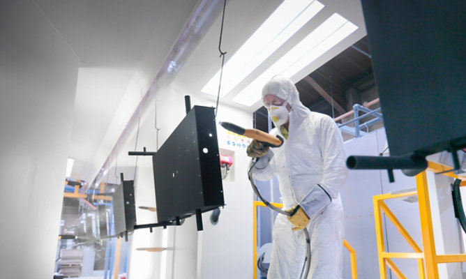 Image of person powder coating part