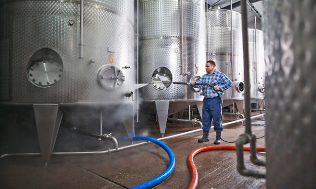 person cleaning in a brewery
