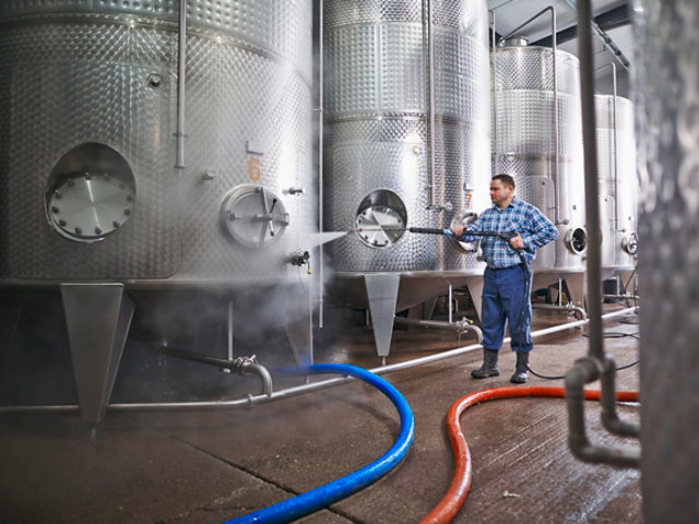 person cleaning at brewery