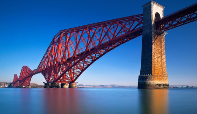 Red steel bridge over water