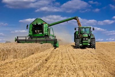 Two green agricultural machines 