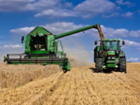 Two green agricultural machines 