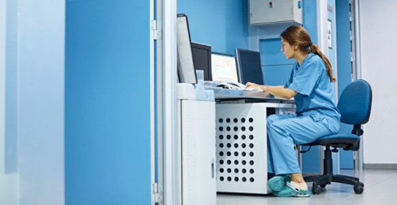 A lab technician working at a computer