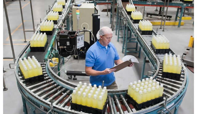 Person working on assembly line at bottling plant