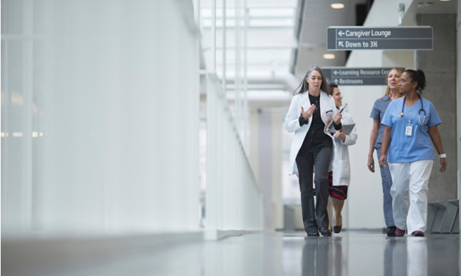 healthcare professionals walking in a hallway of health facility