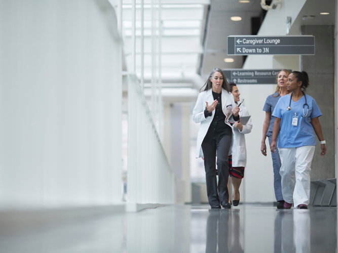 healthcare professionals walking in a hallway of health facility