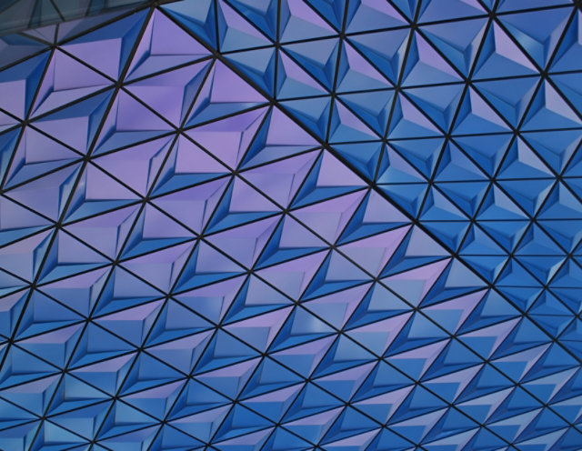 Close up of archetictural building with purple and blue color-shifting geometric pattern