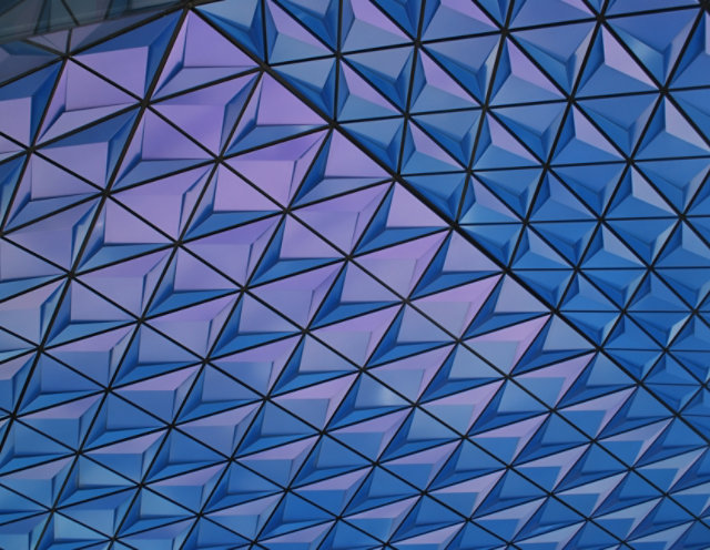 Close up of archetictural building with purple and blue color-shifting geometric pattern