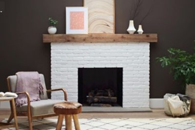 A brick fireplace painted white.