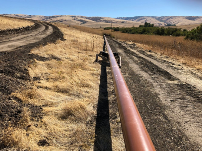 Rack of underground pipe stacked on a rail car