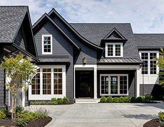 The moody modern shade of Iron Ore SW 7069 (251-C7) gets a contemporary-meets-classic complement of trim in crisp Dover White SW 6385 (261-C2). Photo by Solomon Davis, courtesy of Hatcliff Construction, LLC.