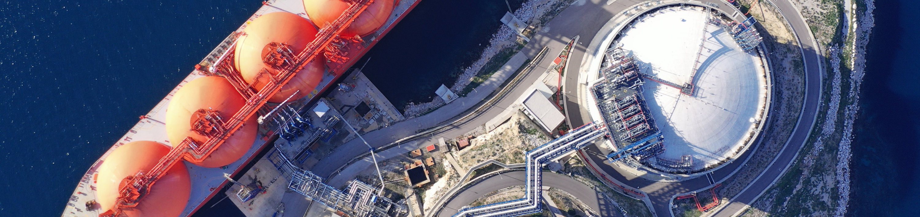 Aerial view of an LNG ship docked at an LNG terminal