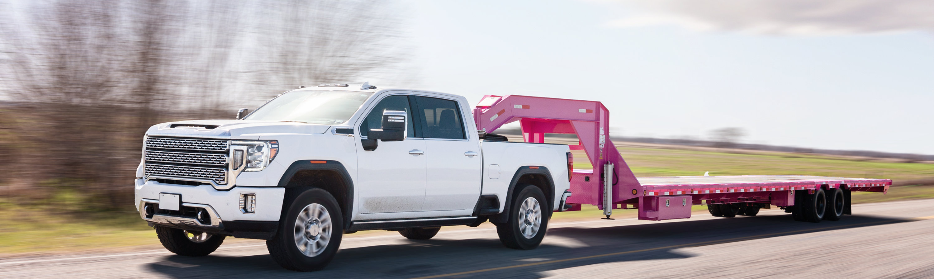White pickup truck pulling trailer